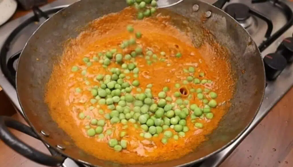 Step 5: Add green peas to the masala